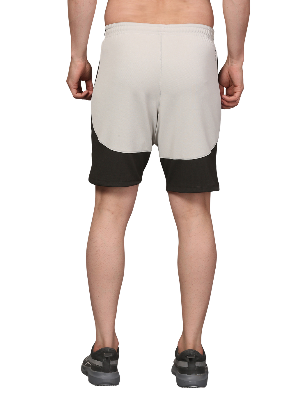 Person wearing beige and black shorts 