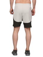 Person wearing beige and black shorts 