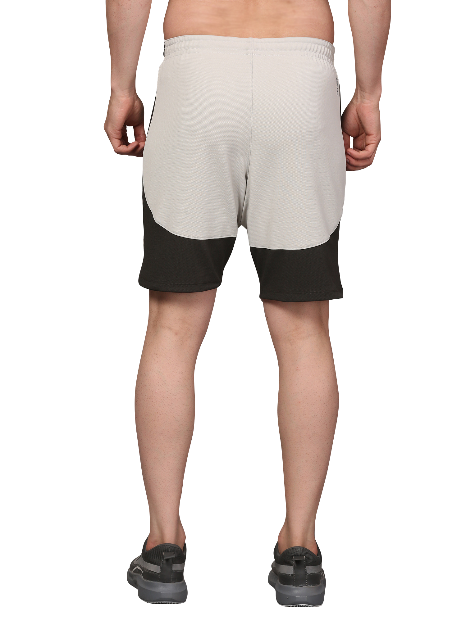 Person wearing beige and black shorts 