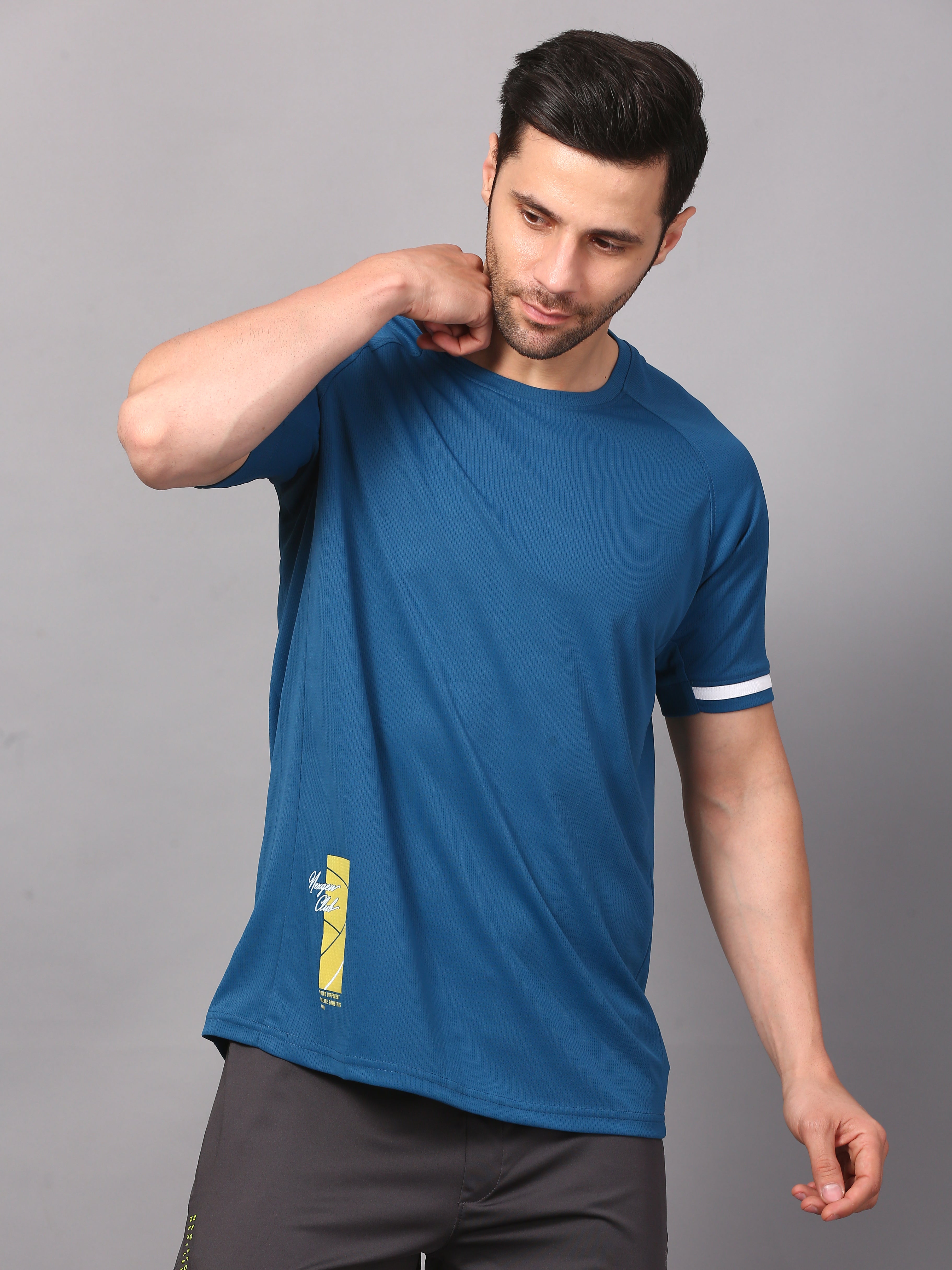 Man wearing a blue athletic shirt with a logo 