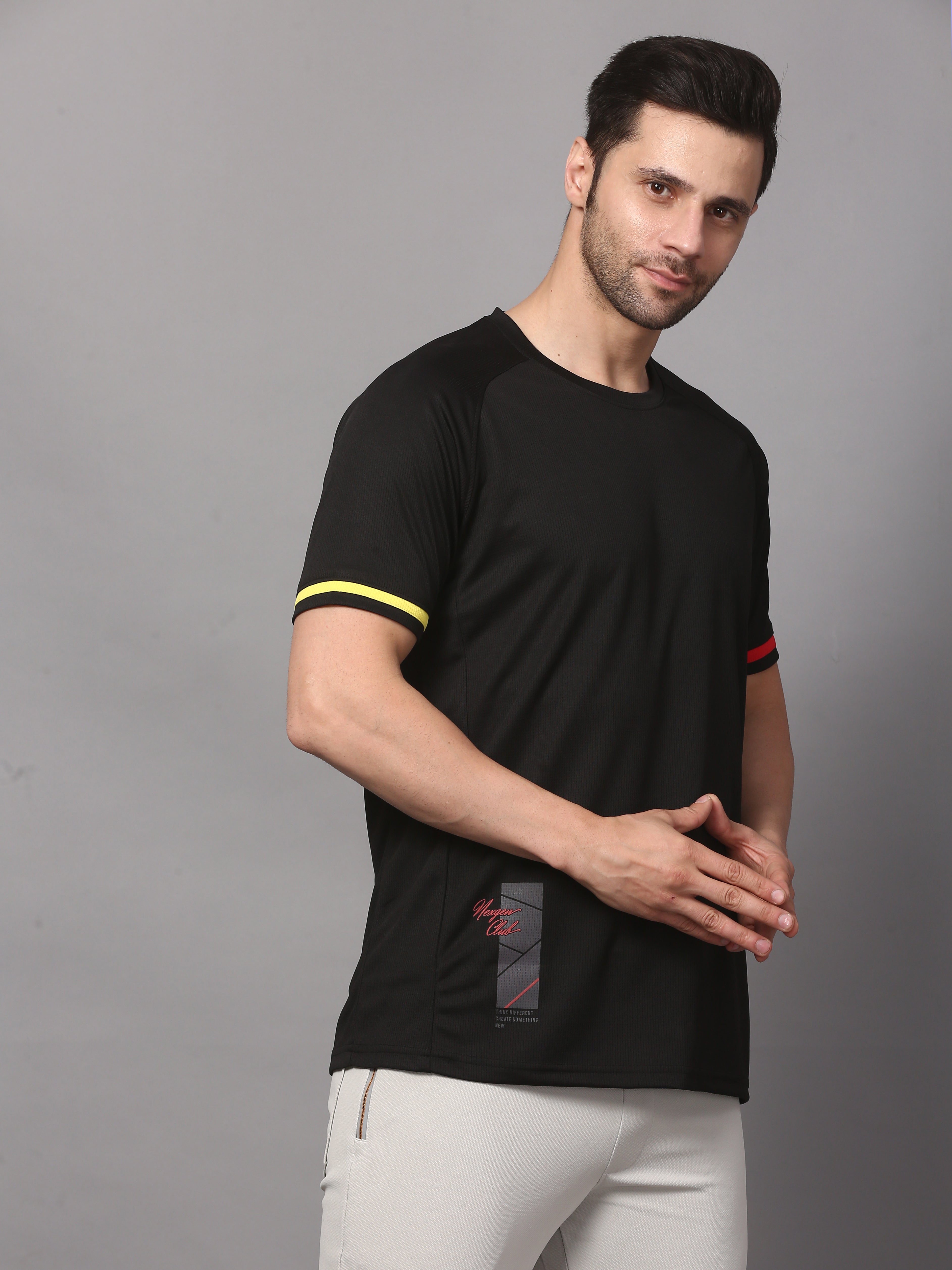 Man wearing a black t-shirt with yellow and red accents 