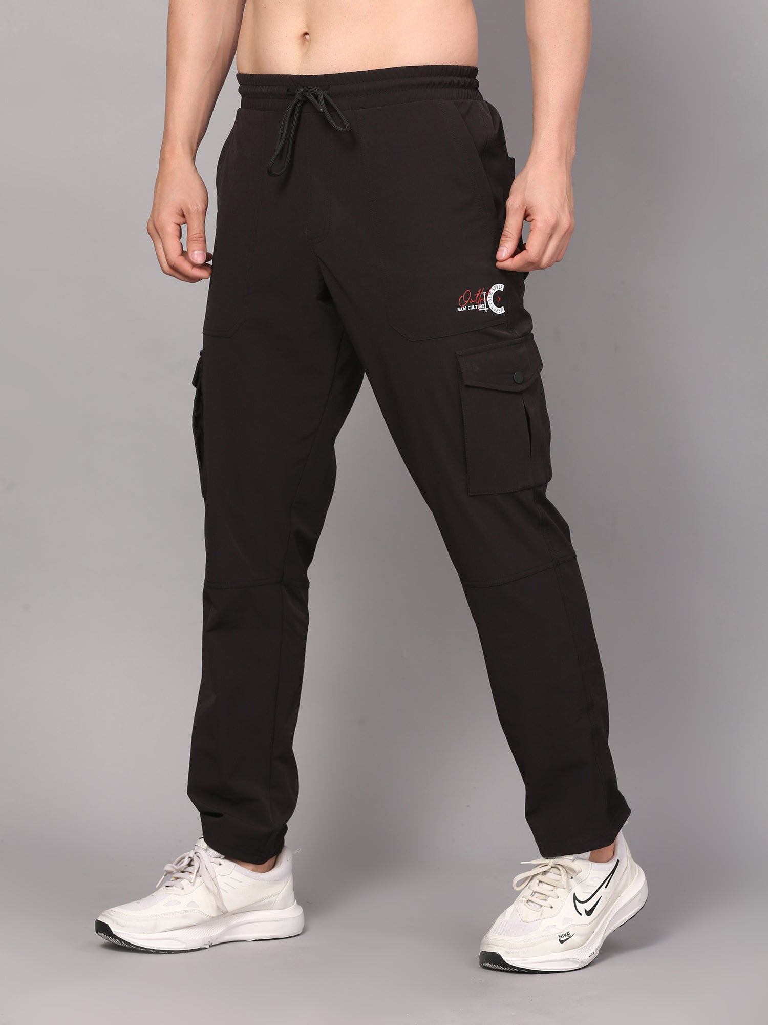 Person wearing black cargo pants with a logo 