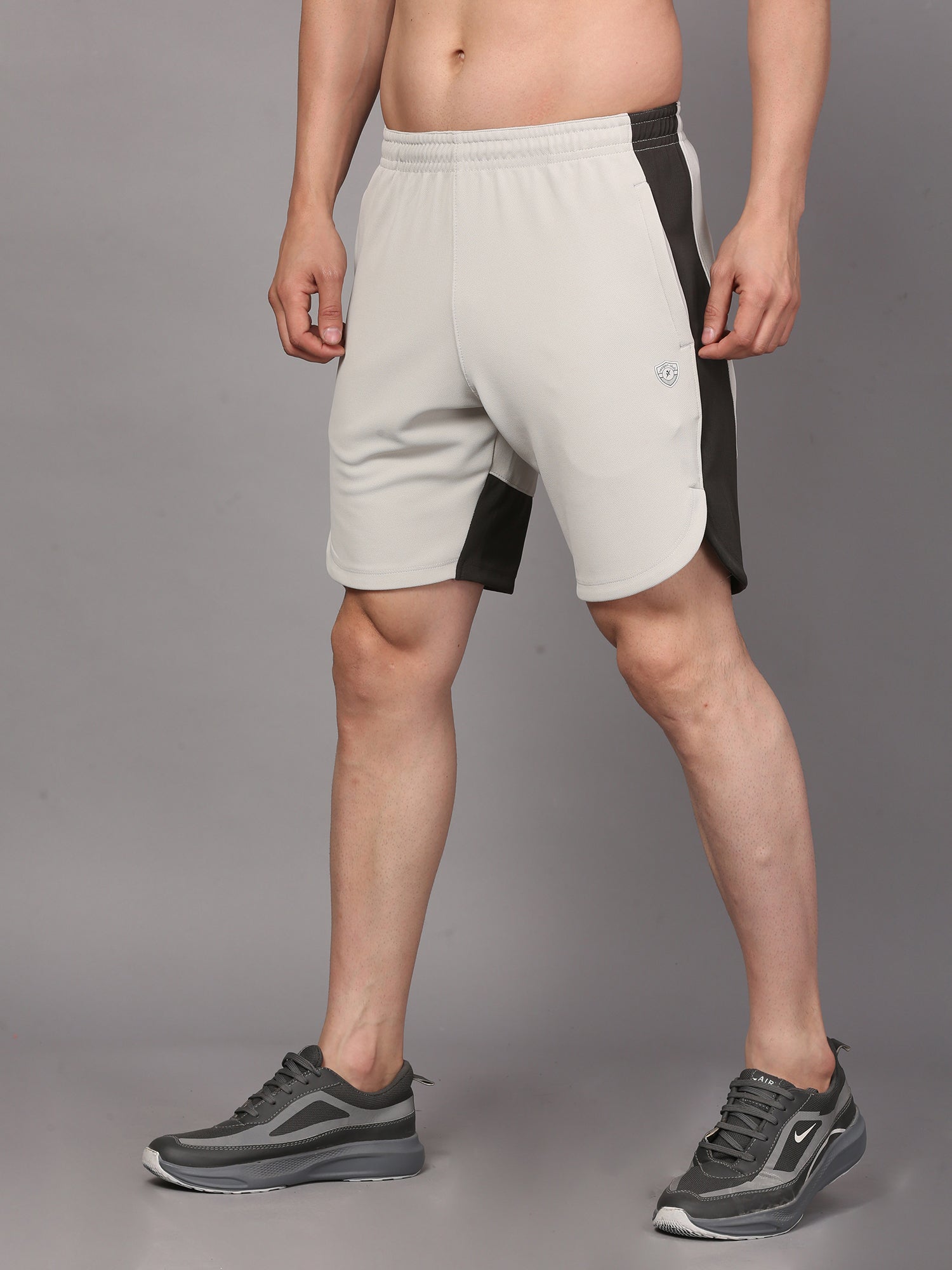 Person wearing light gray shorts with black accents 