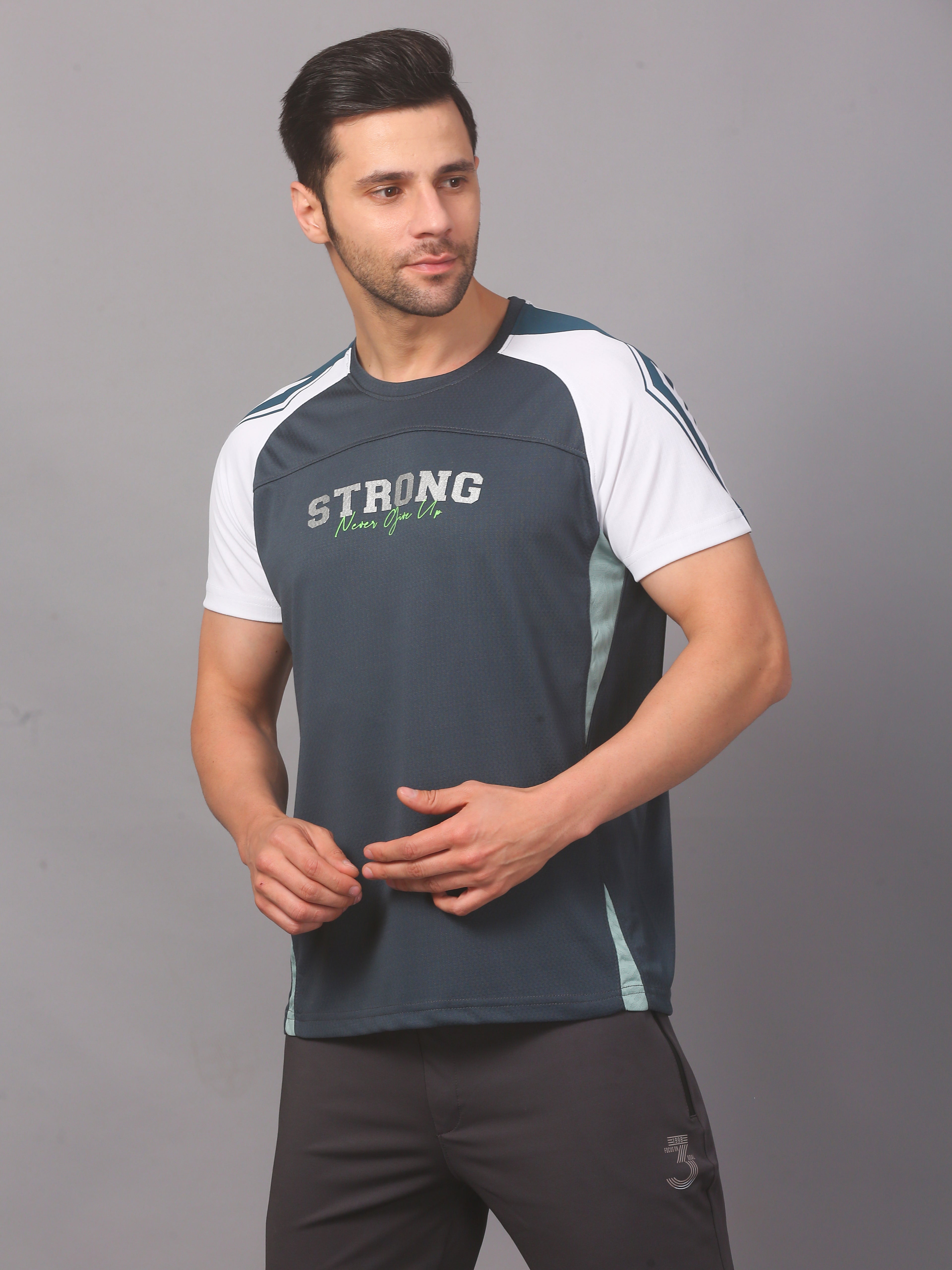 Man wearing a blue athletic shirt with text on a gray background