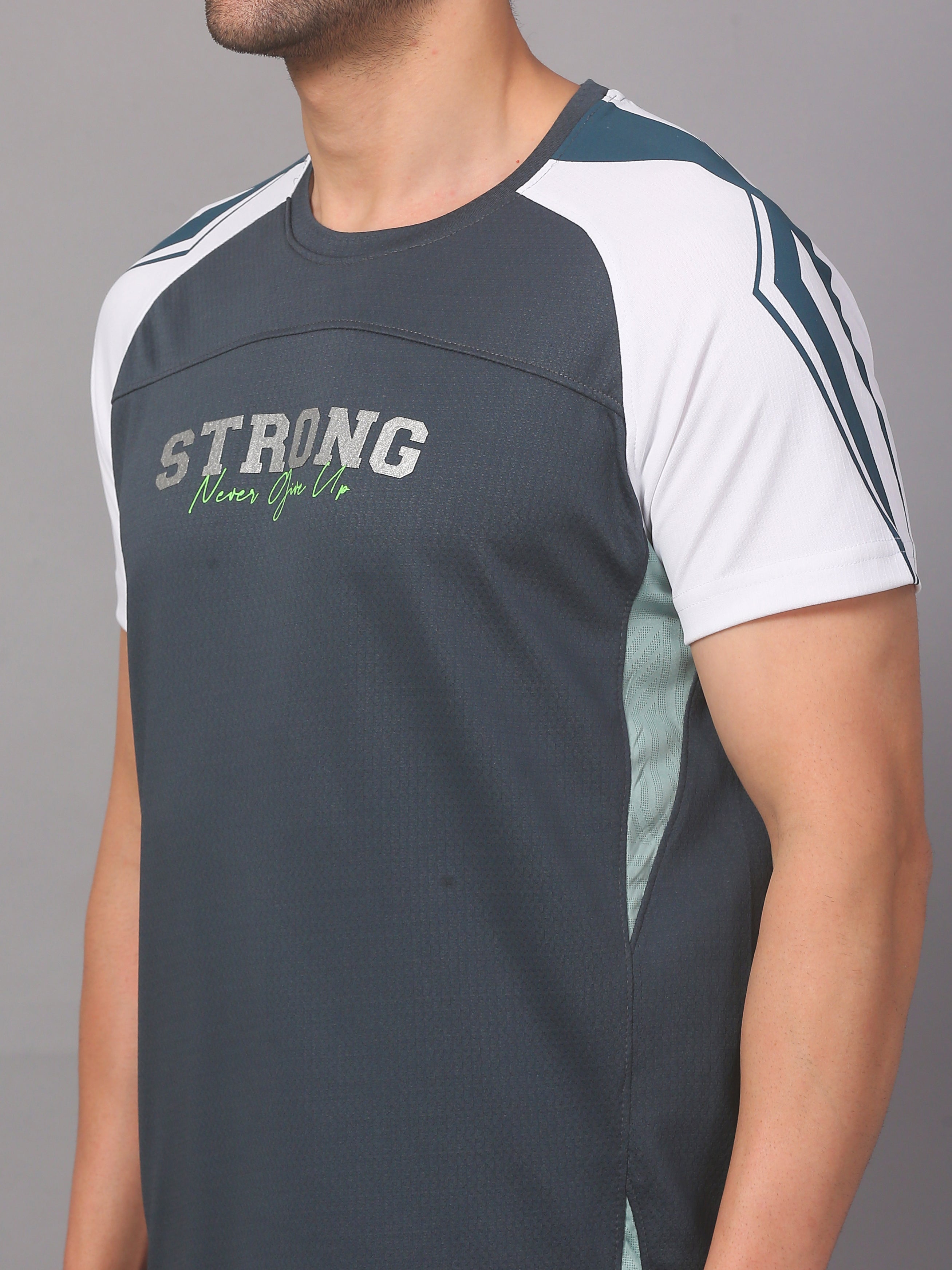 Person wearing a black and white sports shirt with 'STRONG' text on a gray background