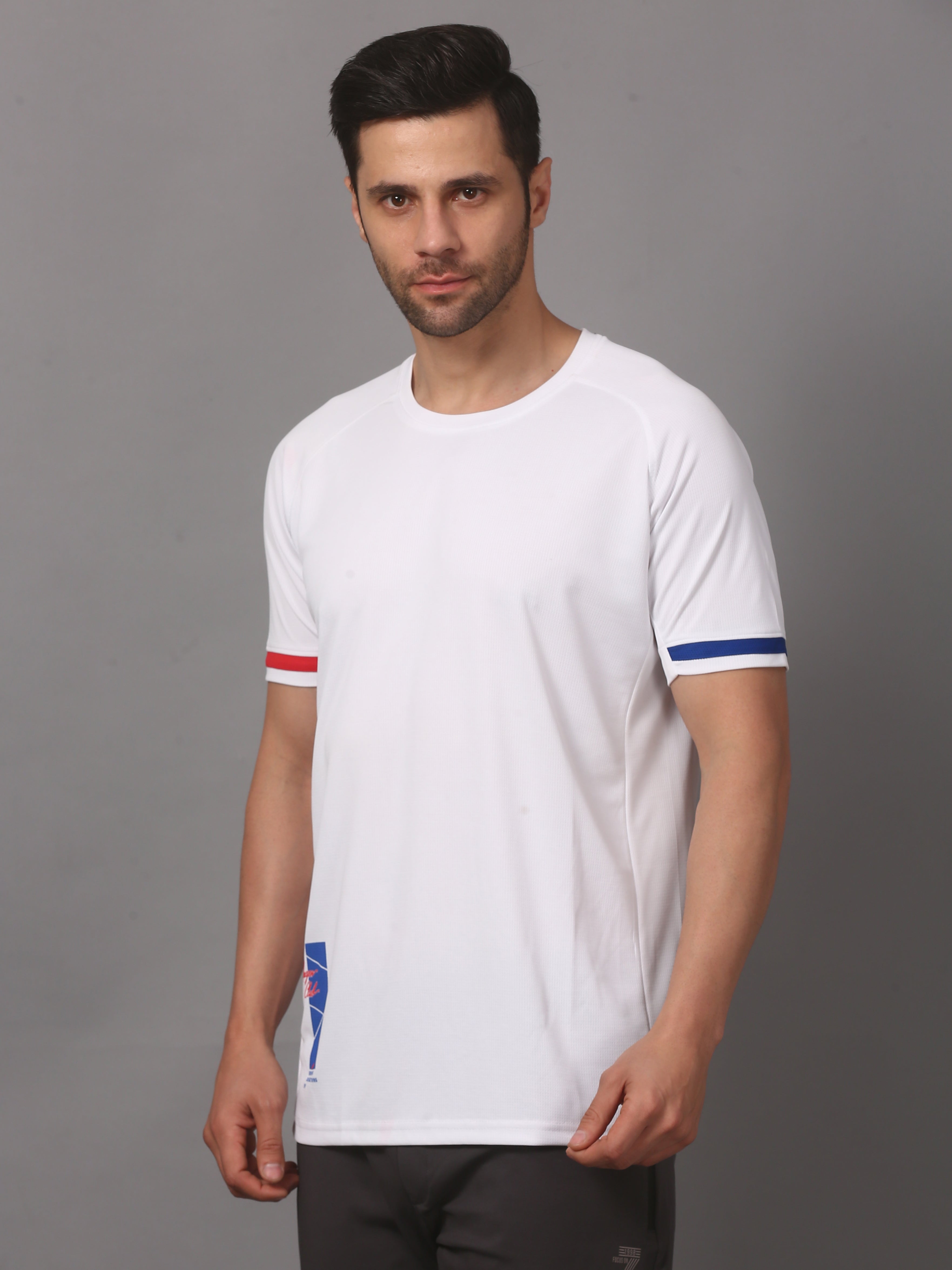 Man wearing a white t-shirt with red and blue accents