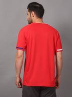 Man wearing a red t-shirt with white and blue accents 