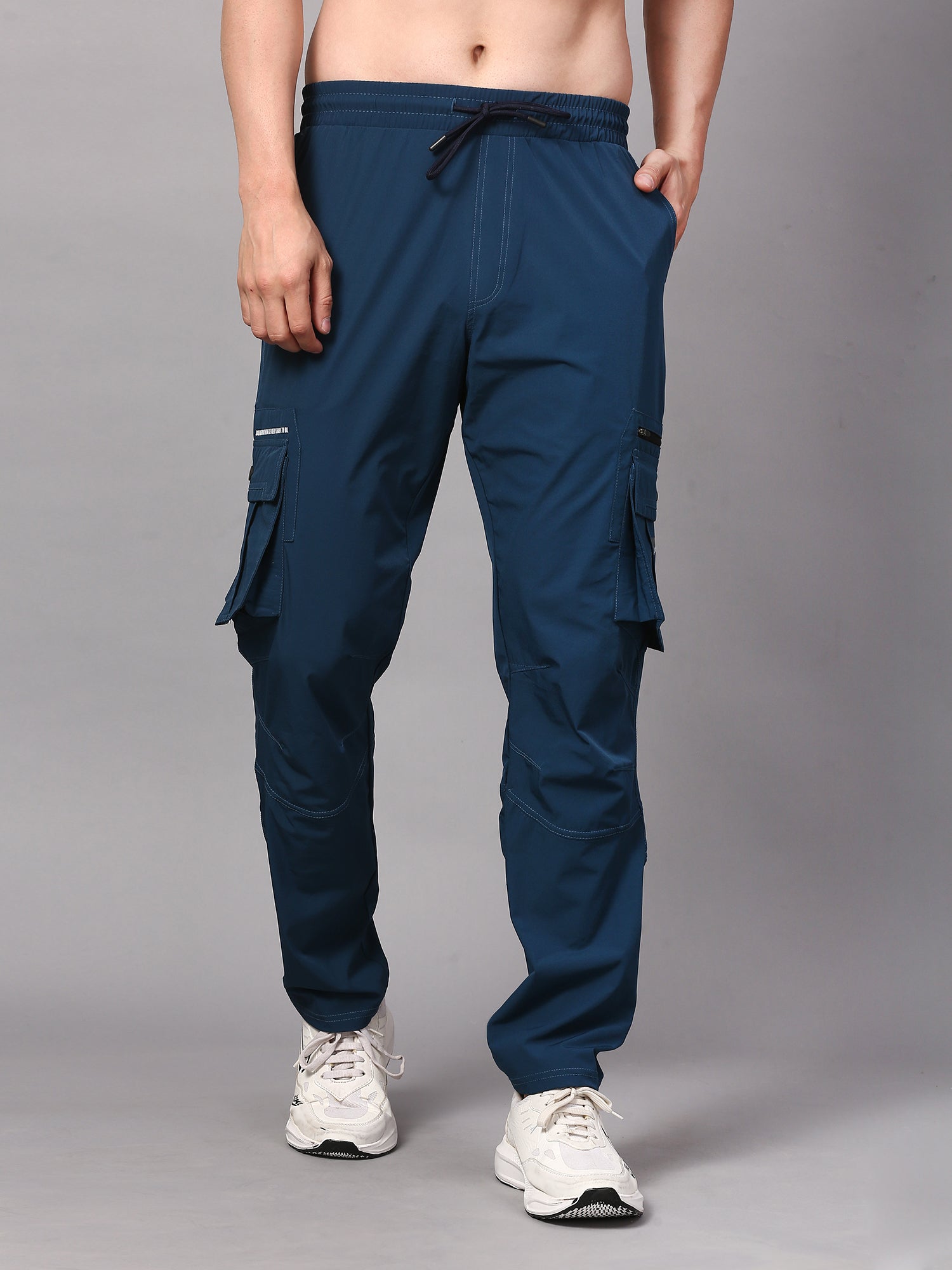 a pair of cargo pants, designed for a comfortable and functional fit. The pants are detailed with multiple pockets, including large side pockets and a belt loop for adjustability.
