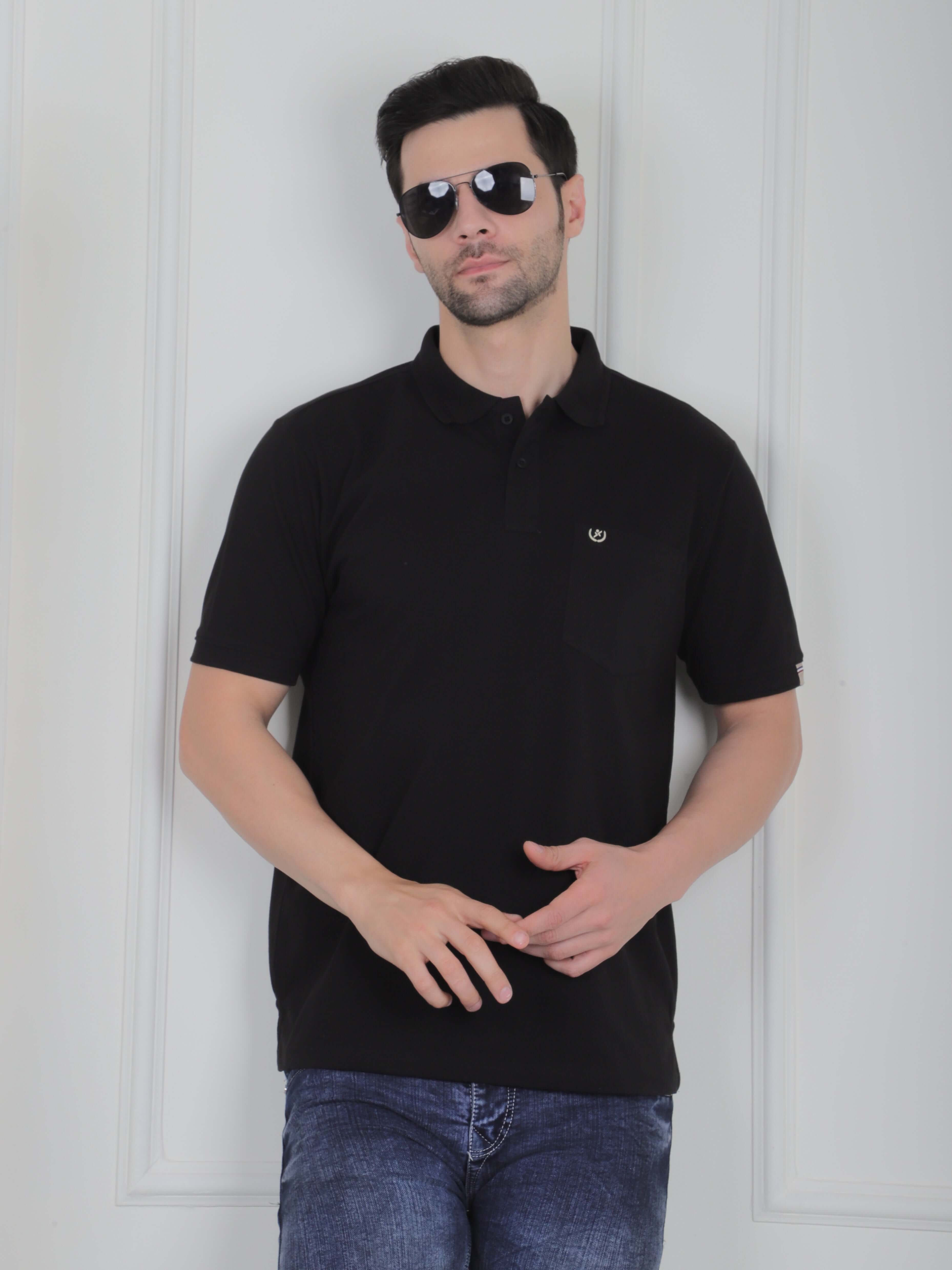 Man in black men’s polo t-shirt with chest embroidery, wearing sunglasses, showcasing smart casual style.