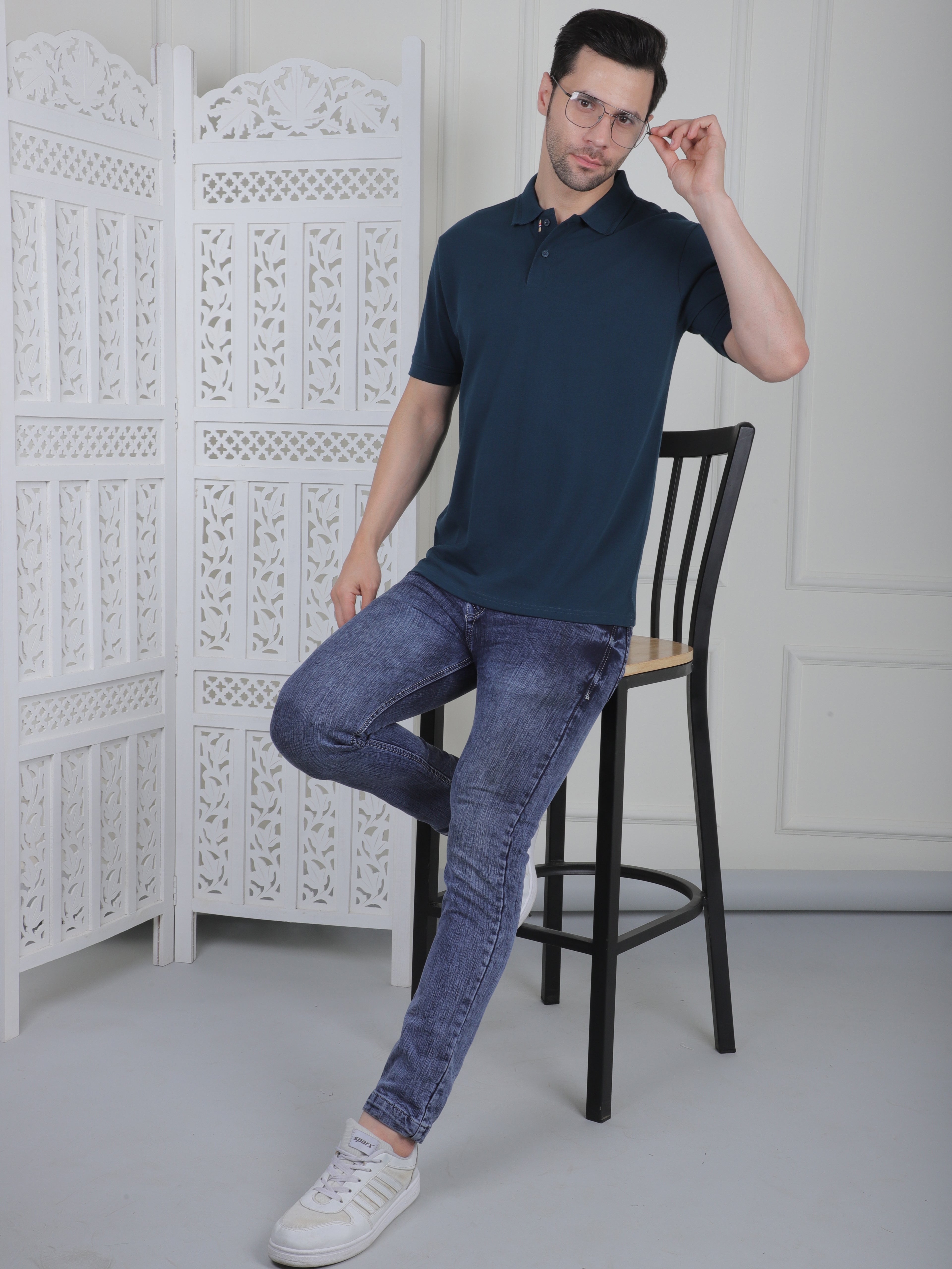 Man wearing a emerald green polo shirt