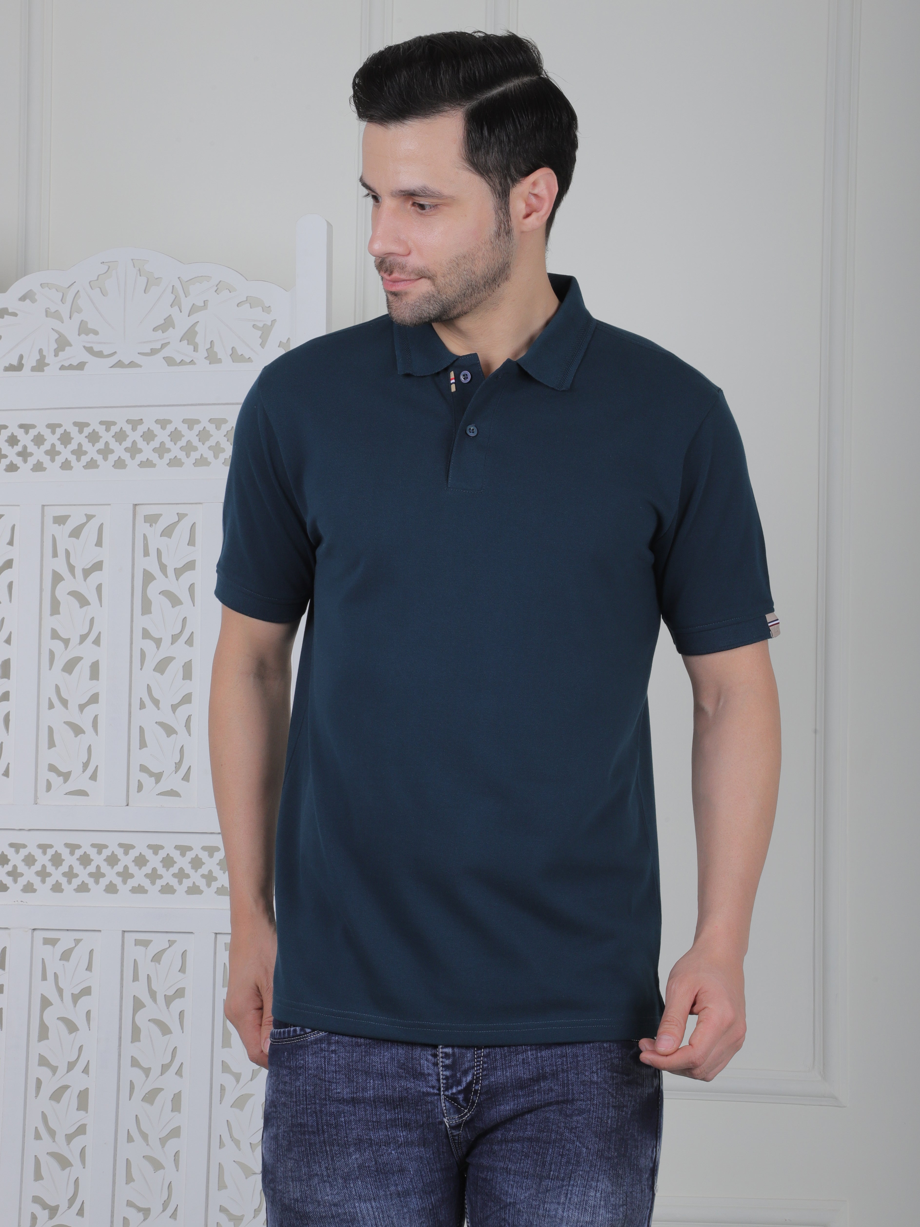 Man wearing a emerald green polo shirt