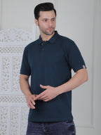 Man wearing an emerald green polo shirt