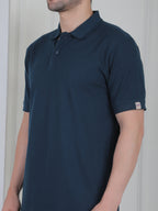 Man wearing a emerald green polo shirt