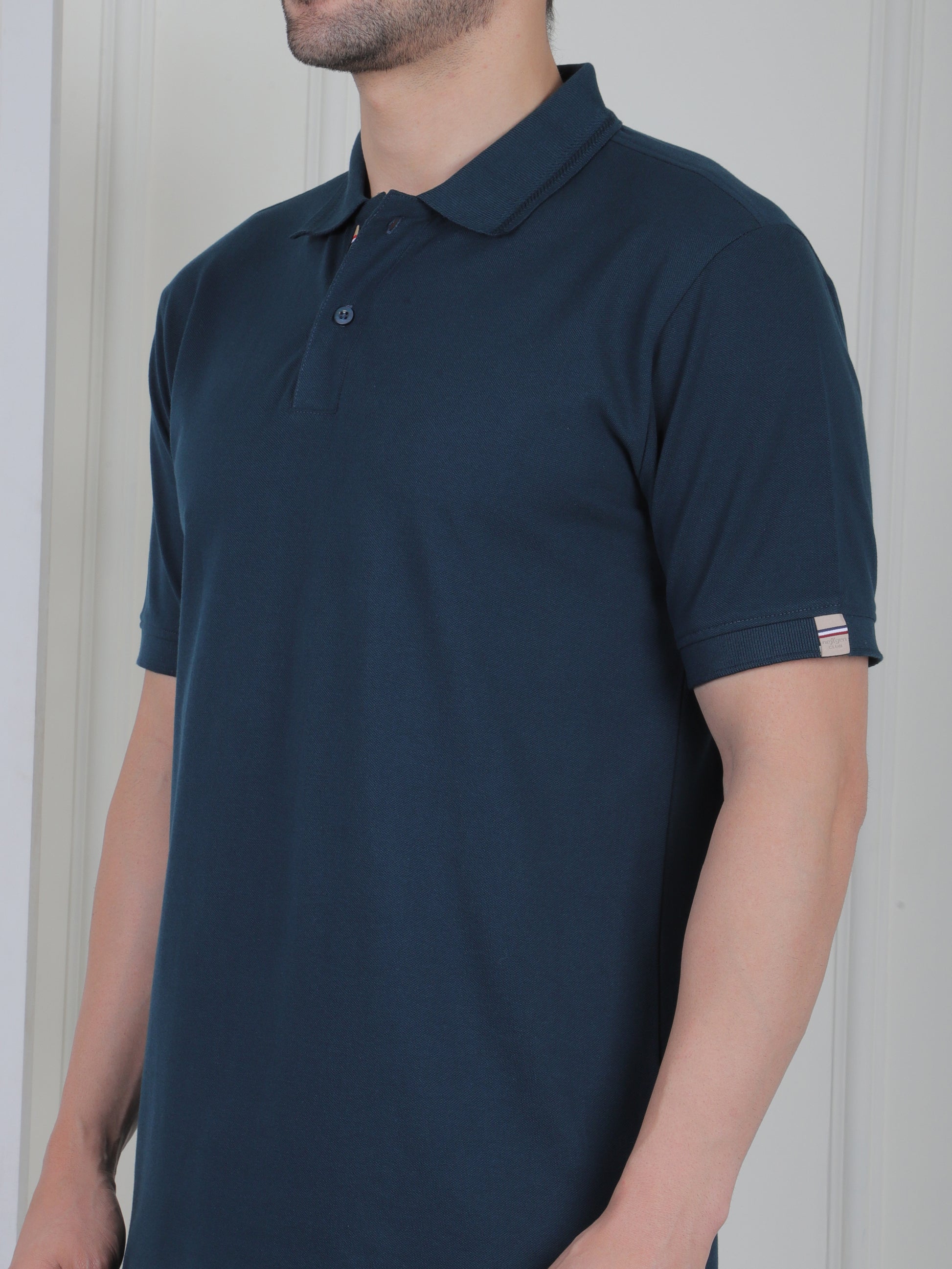 Man wearing a emerald green polo shirt