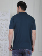 Man wearing a emerald green polo shirt