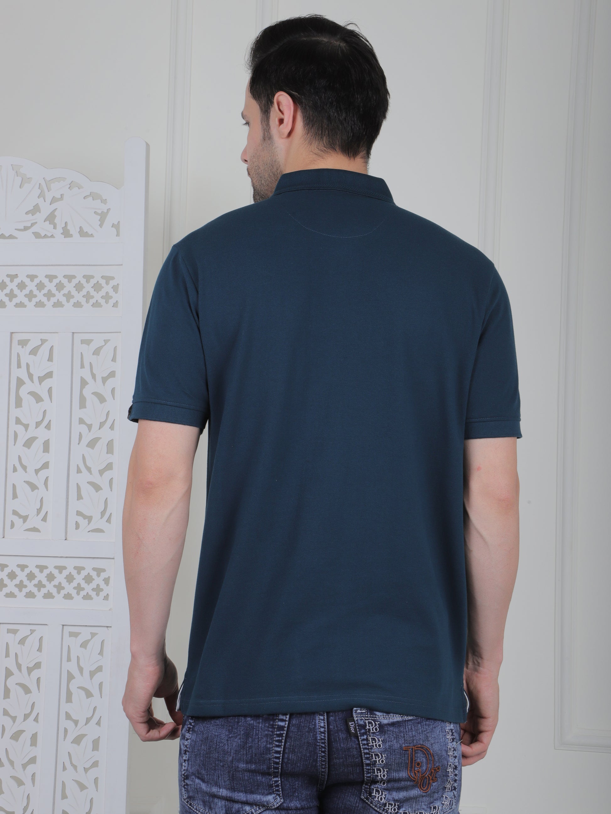 Man wearing a emerald green polo shirt