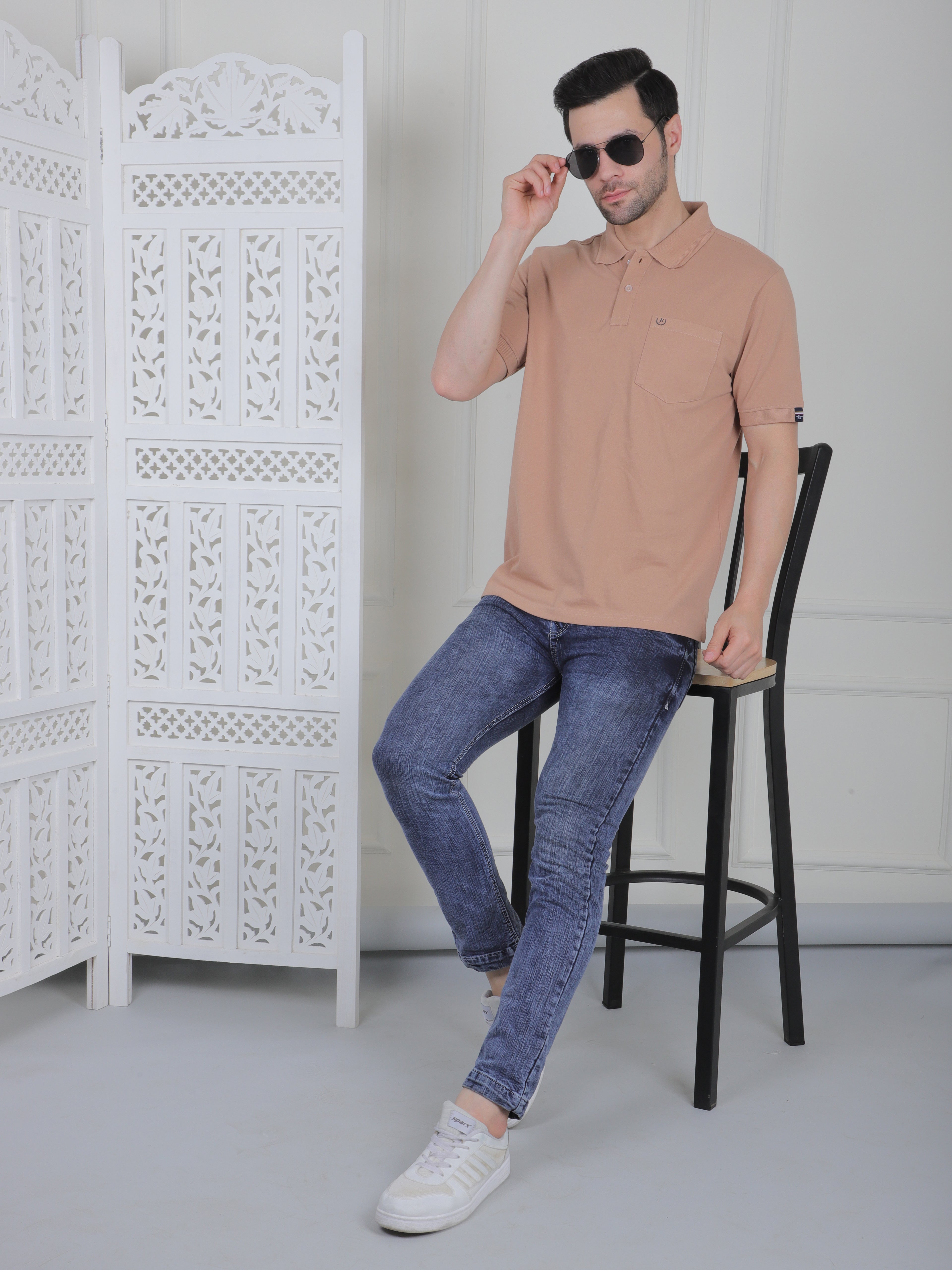 Man wearing a beige polo shirt