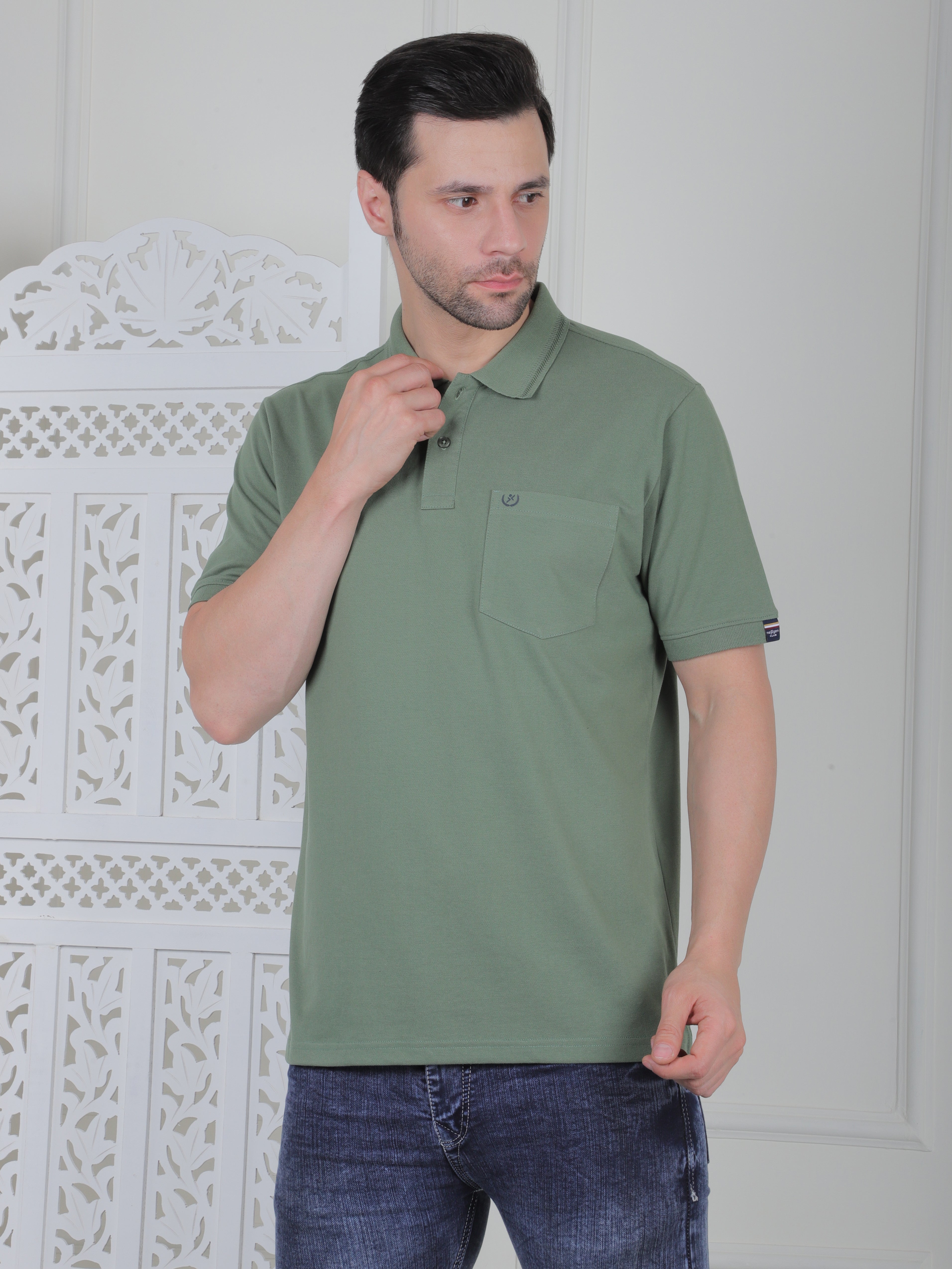 Man wearing a sage polo shirt