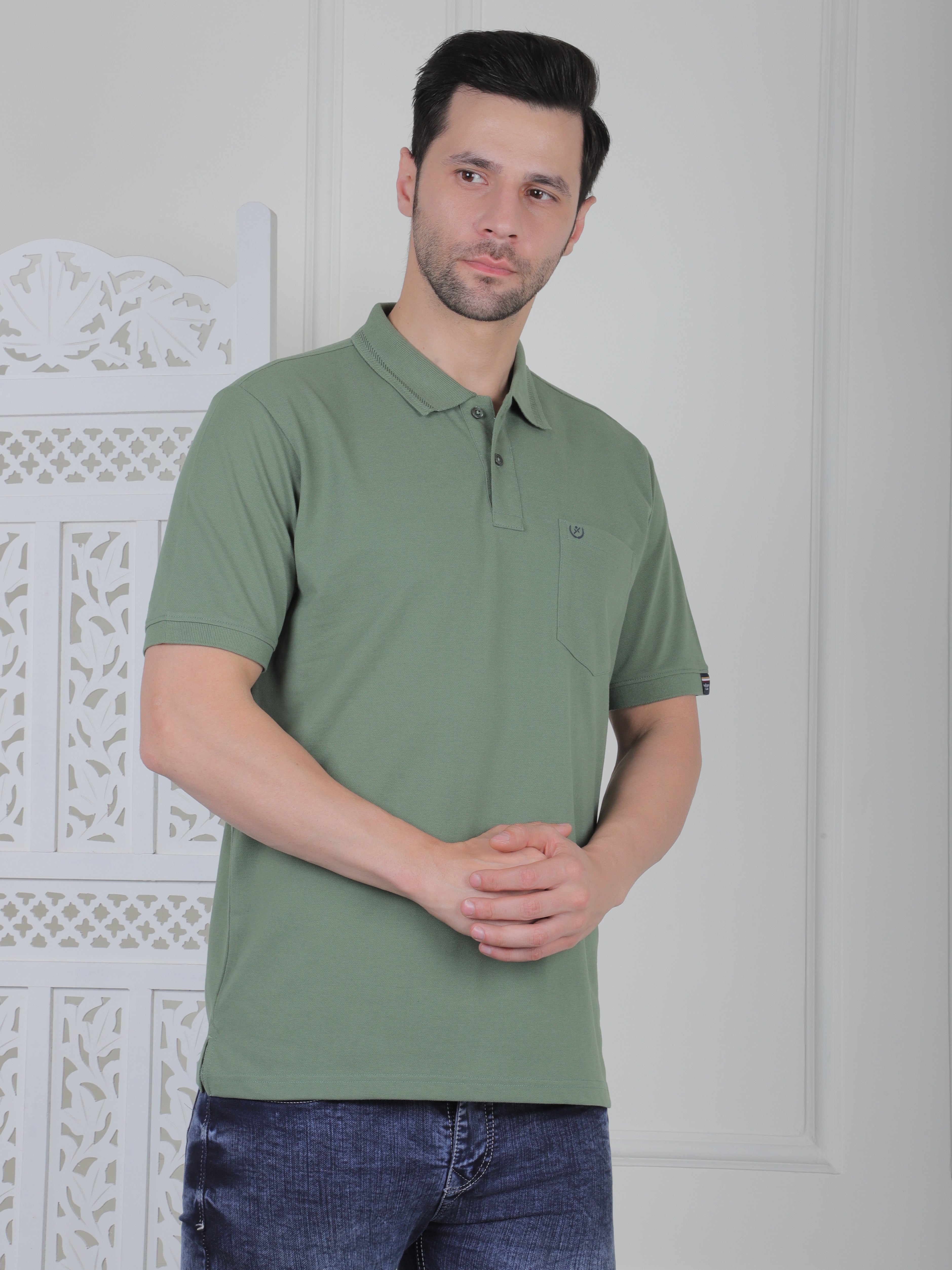 A sage green polo shirt with pockets