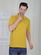 A mustard polo shirt with pockets
