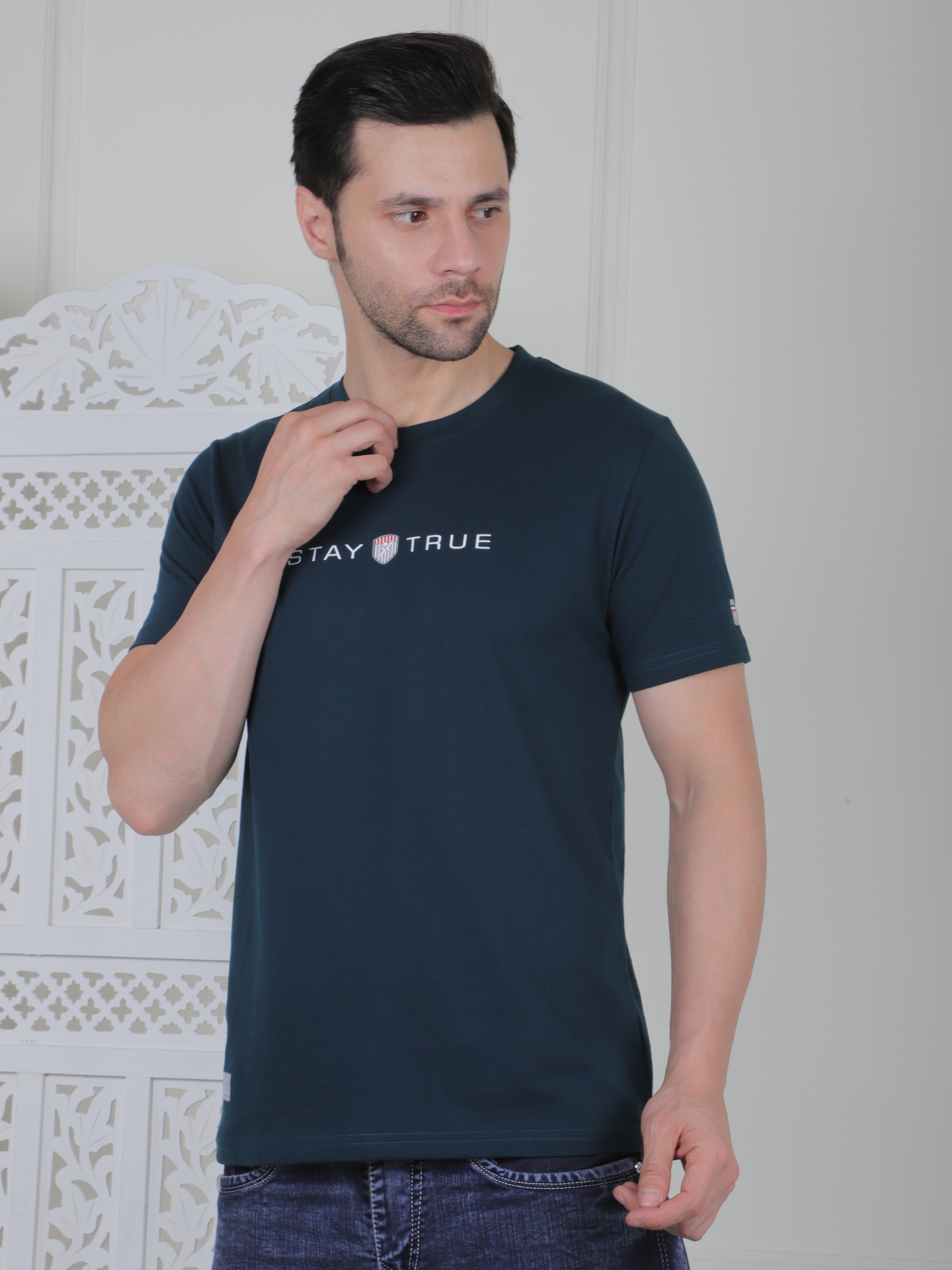 Man wearing a navy blue t-shirt with design