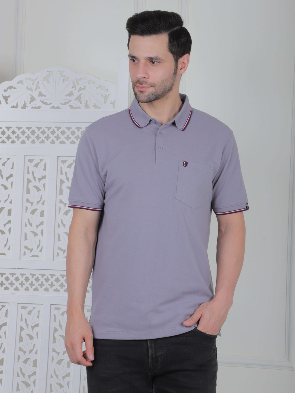 A silver grey polo shirt with pocket and piping details