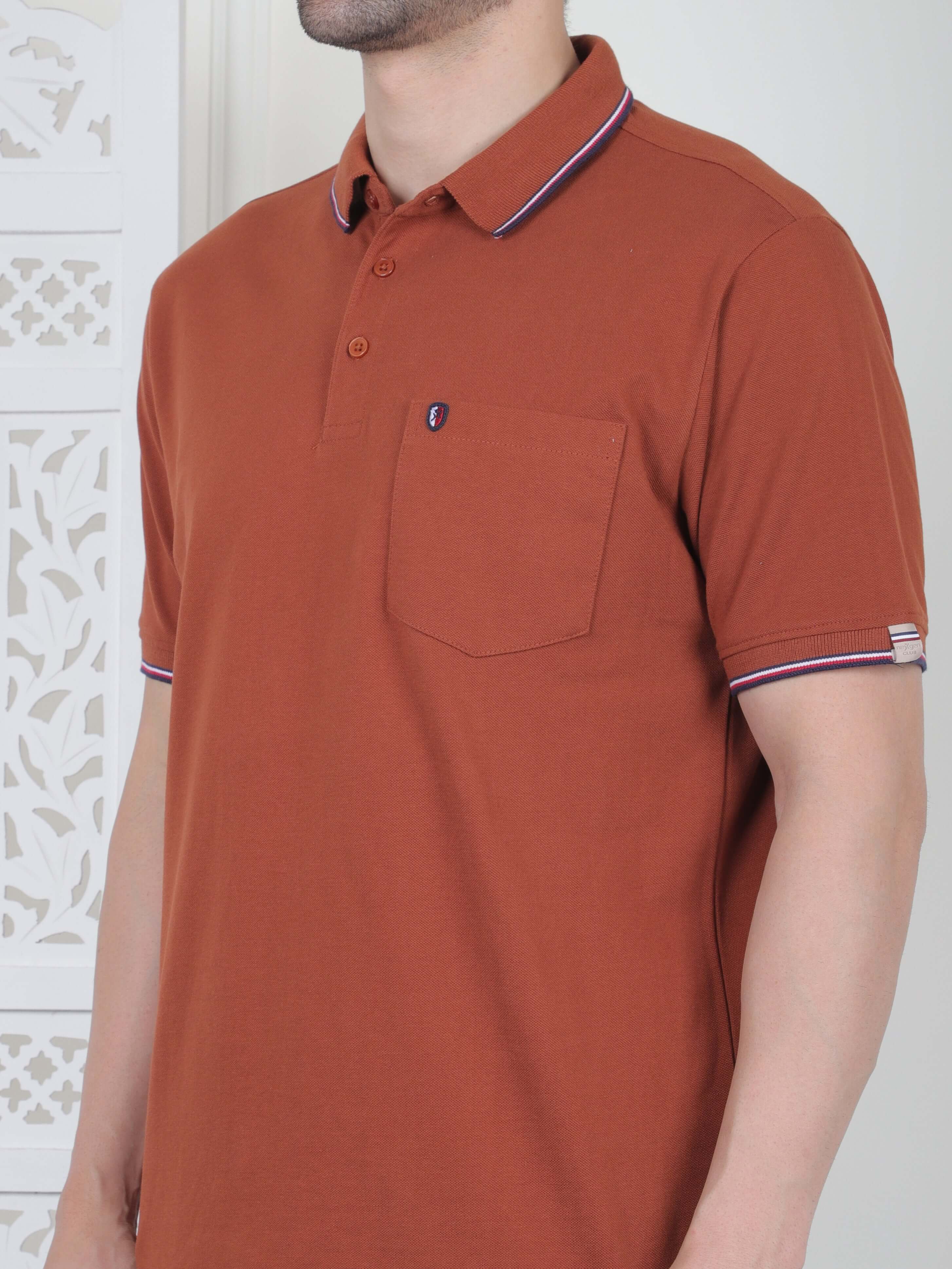 A rust brown polo shirt with pocket and piping details
