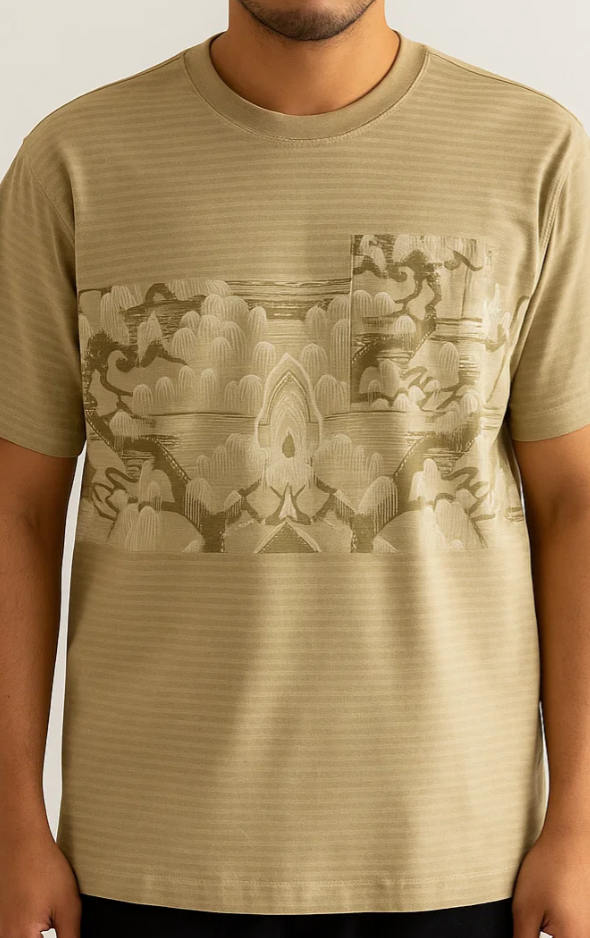 Beige t-shirt with a geometric pattern worn by a person on a plain background